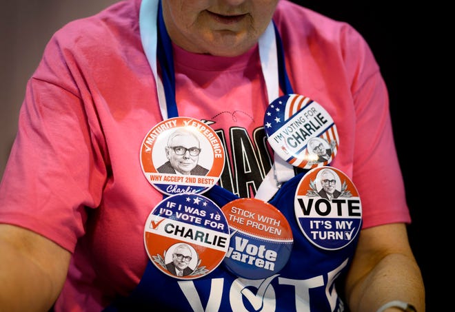 A salesperson wears pins of Warren Buffett, CEO of Berkshire Hathaway, and Vice Chairman Charlie Munger during the annual Berkshire shareholders meeting in Omaha, Nebraska, May 3, 2019.