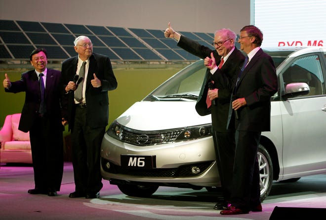 From right, Microsoft Corporation founder Bill Gates, American investor Warren Buffett, Charlie Munger, vice chairman of Berkshire Hathaway and Chinese tycoon, BYD Chairman Wang Chuanfu gesture after unveiling BYD's new M6 in Beijing, China Wednesday, Sept. 29, 2010.