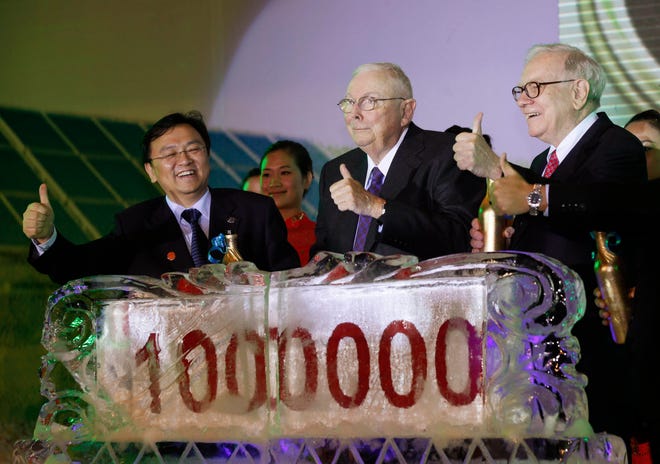 From right, American investor Warren Buffett, Charlie Munger, vice chairman of Berkshire Hathaway and Chinese tycoon, BYD Chairman Wang Chuanfu show their thumb up during BYD's 1 million Auto Sales Celebration Ceremony in Shenzhen city, Guangdong province, Monday September 27, 2010. Warren Buffett's backing gave Chinese battery and automaking tycoon Wang a huge boost, and on paper represents at least a six-fold return on the investment. Beginning Monday, Wang's BYD Autos is launching a series of events in three Chinese cities meant to showcase the company's electric vehicles and energy strategy, and perhaps to reassure the billionaire investor from Omaha.