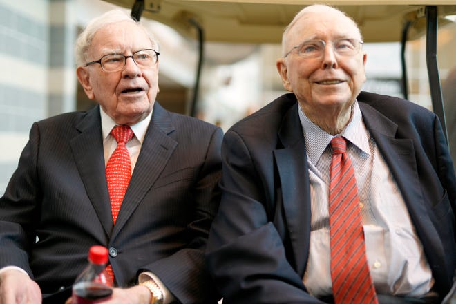 Berkshire Hathaway Chairman and CEO Warren Buffett, left, and Vice Chairman Charlie Munger, briefly chat with reporters May 3, 2019, one day before Berkshire Hathaway's annual shareholders meeting in Omaha, Neb.